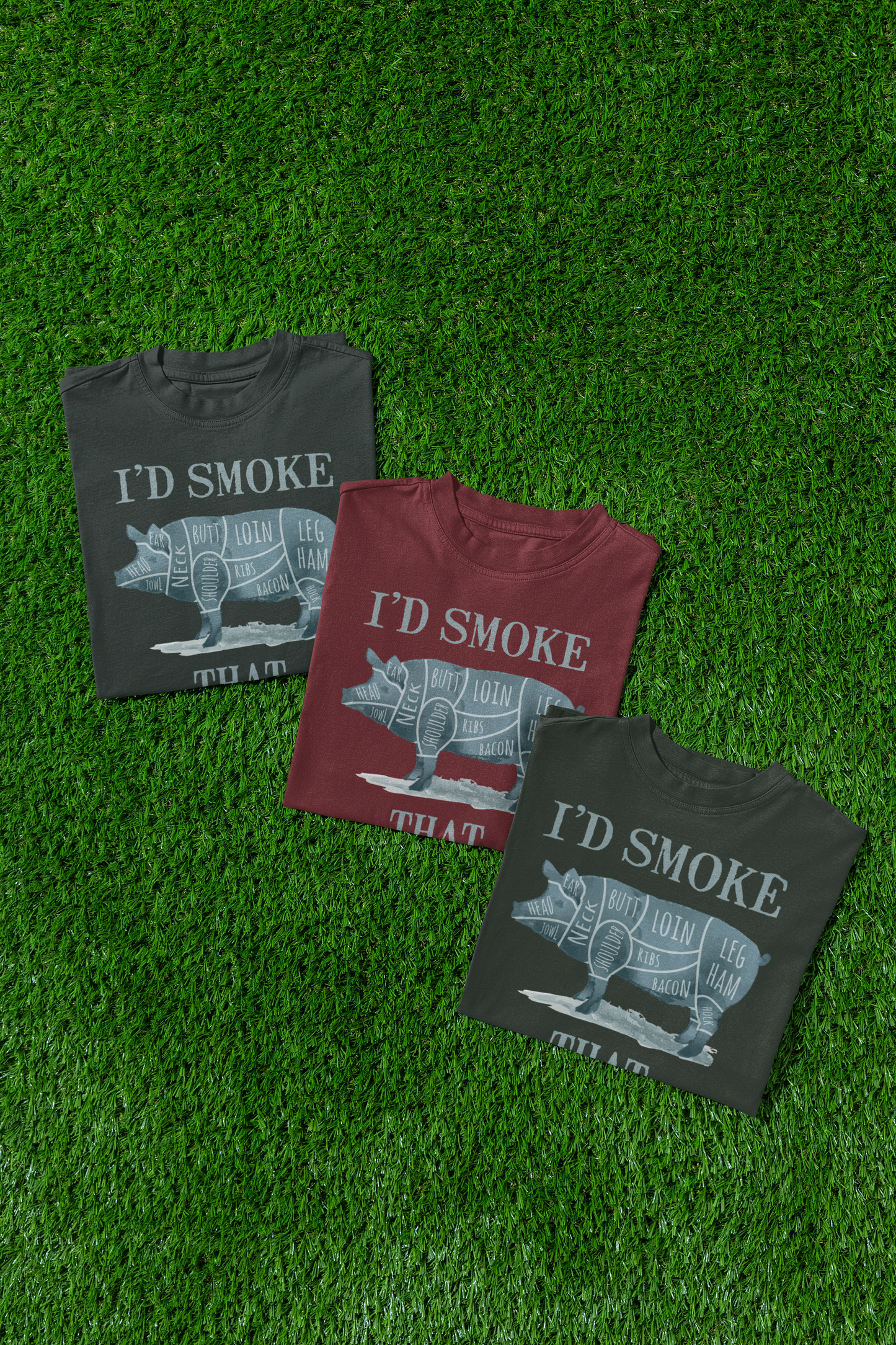 Three t-shirts with 'I'd Smoke That' graphic on a grass background